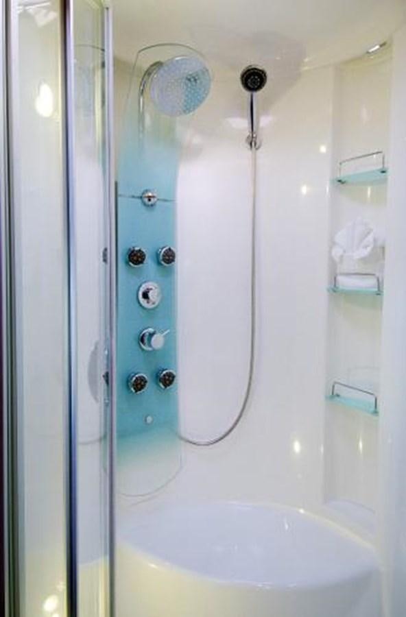 a white bathtub with a shower head and a shower head aboard 74' PRIVILEGE 2010 Yacht for Sale