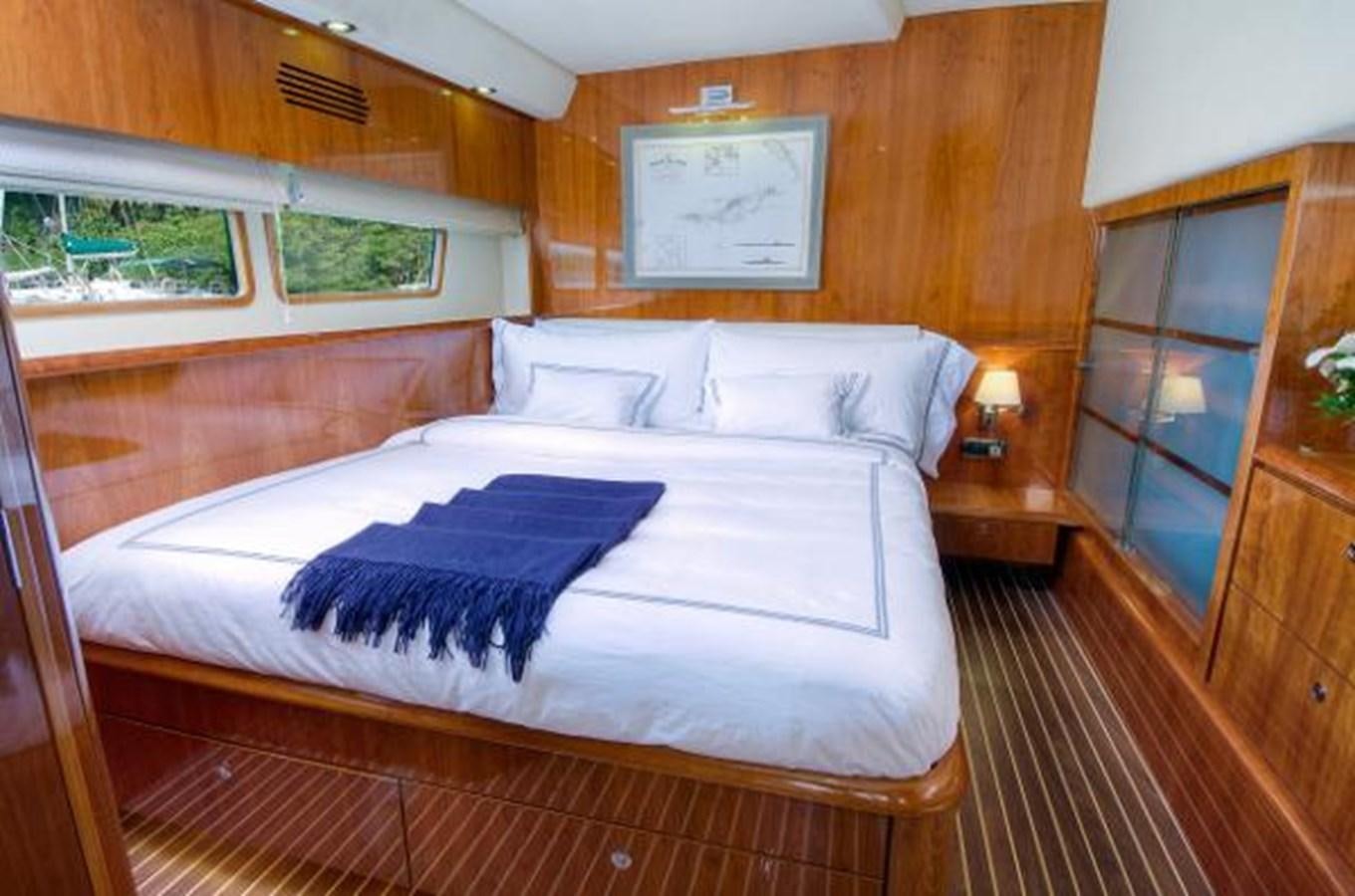 a bed in a room aboard 74' PRIVILEGE 2010 Yacht for Sale