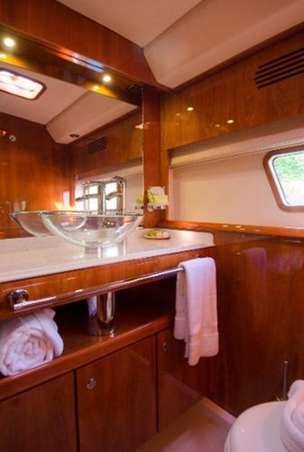 a kitchen with a sink and cabinets aboard 74' PRIVILEGE 2010 Yacht for Sale