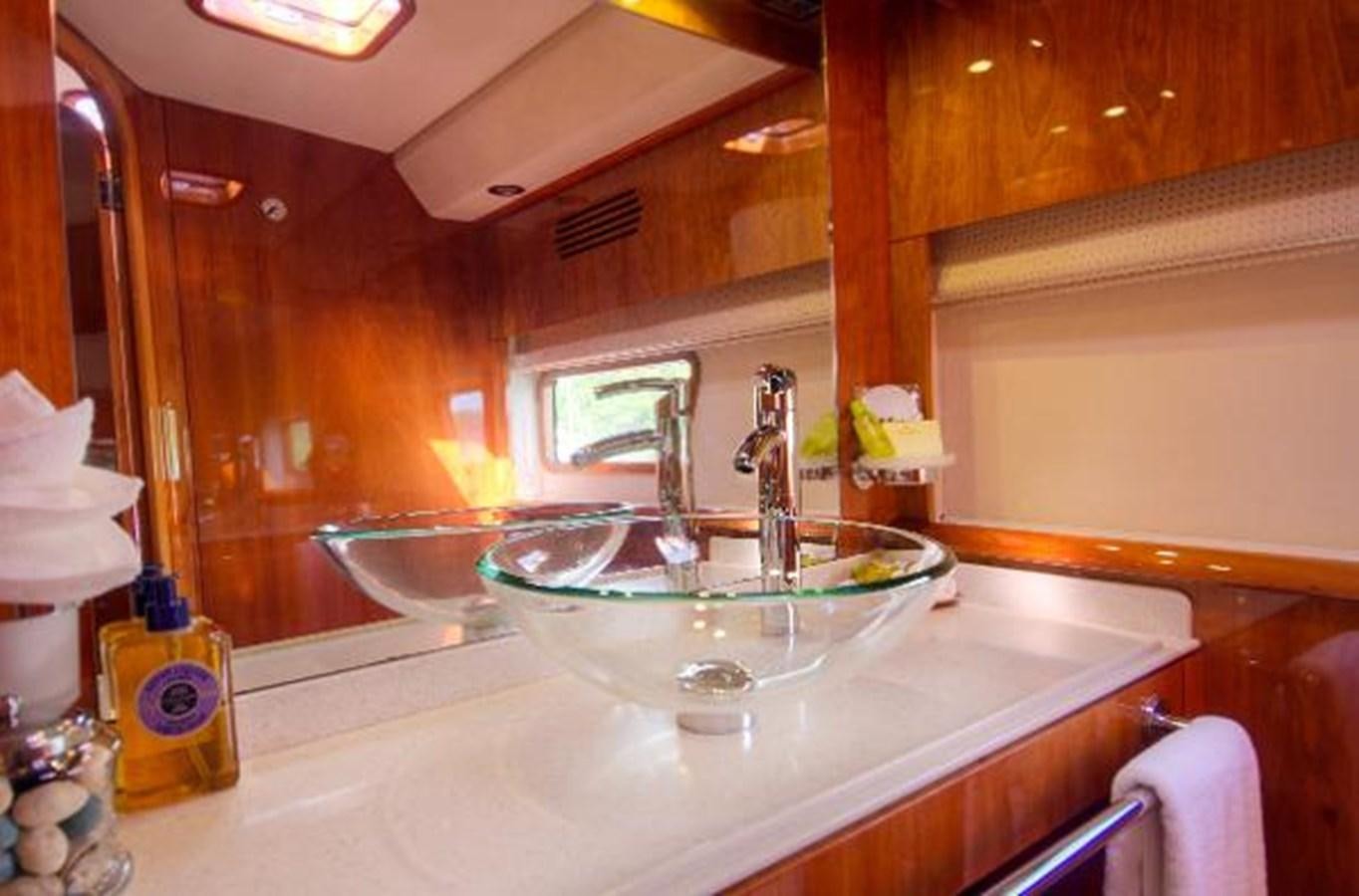 a bathroom with a sink and a mirror aboard 74' PRIVILEGE 2010 Yacht for Sale