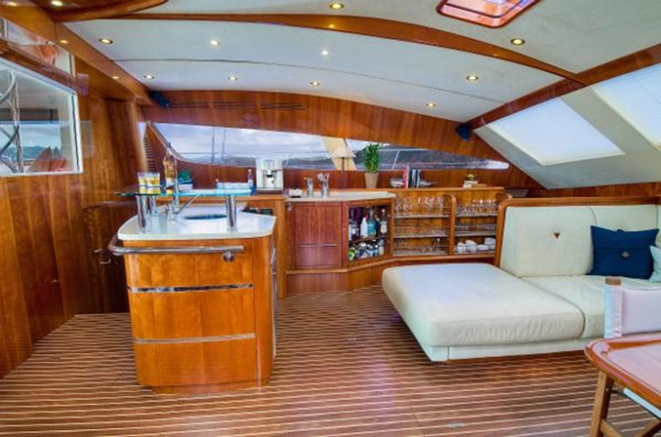 a room with a couch and a table aboard 74' PRIVILEGE 2010 Yacht for Sale