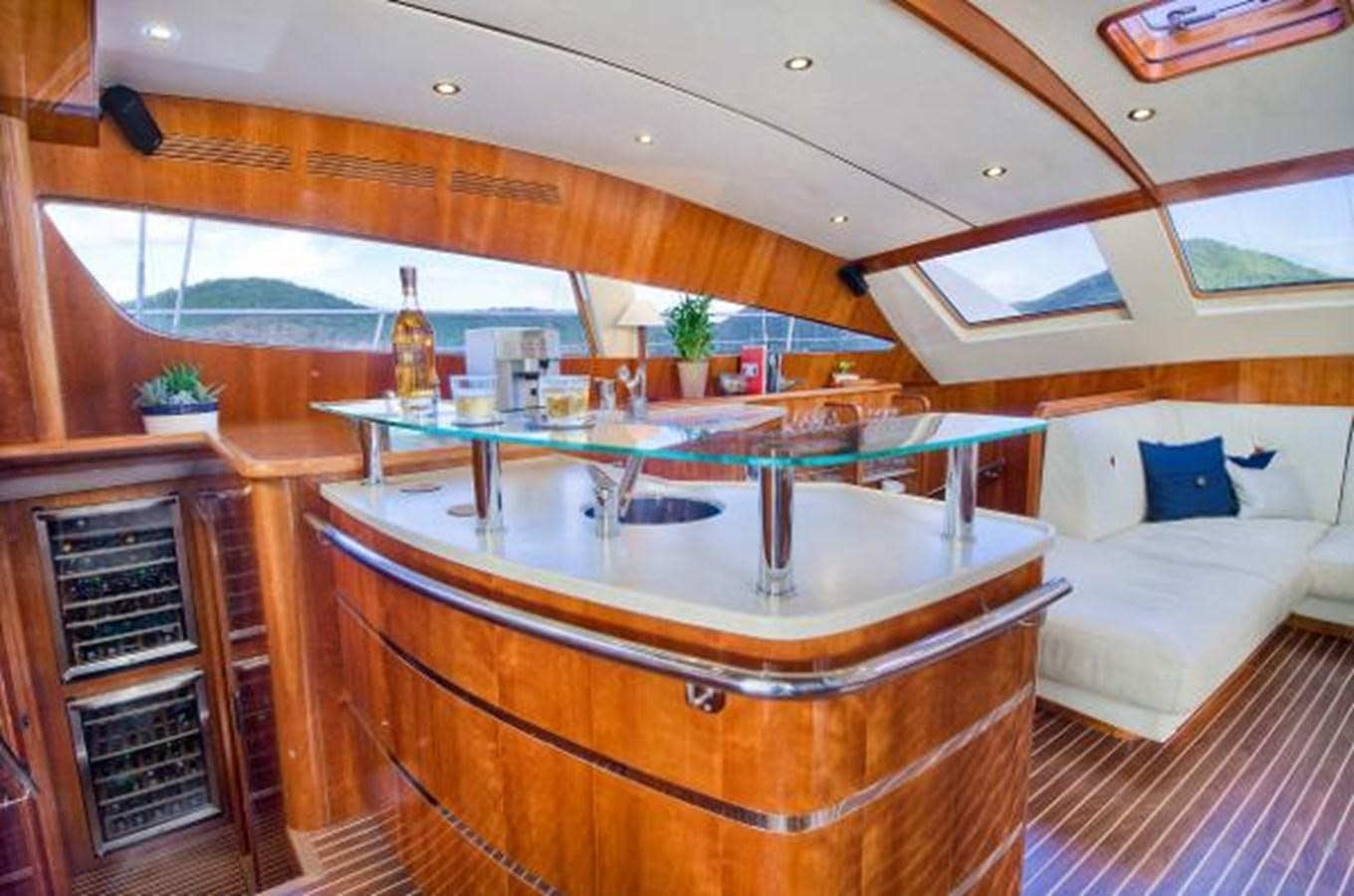 a room with a table and a couch aboard 74' PRIVILEGE 2010 Yacht for Sale