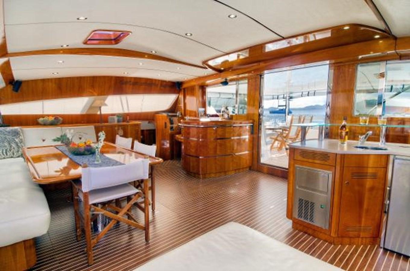 a large room with a table and chairs aboard 74' PRIVILEGE 2010 Yacht for Sale