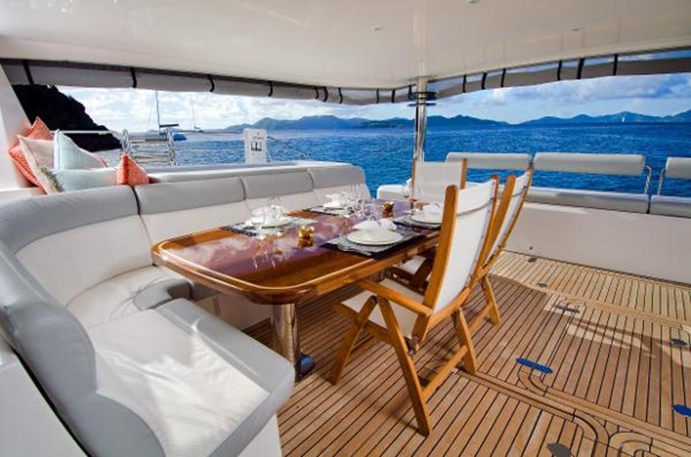 a table and chairs on a deck aboard 74' PRIVILEGE 2010 Yacht for Sale