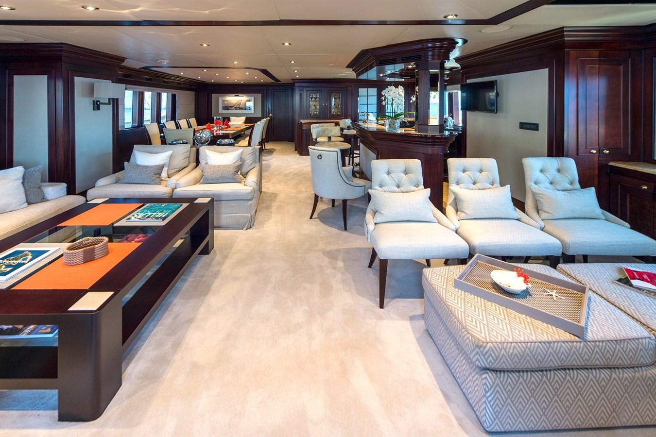 a living room with a table and chairs aboard LIBERTA Yacht for Sale