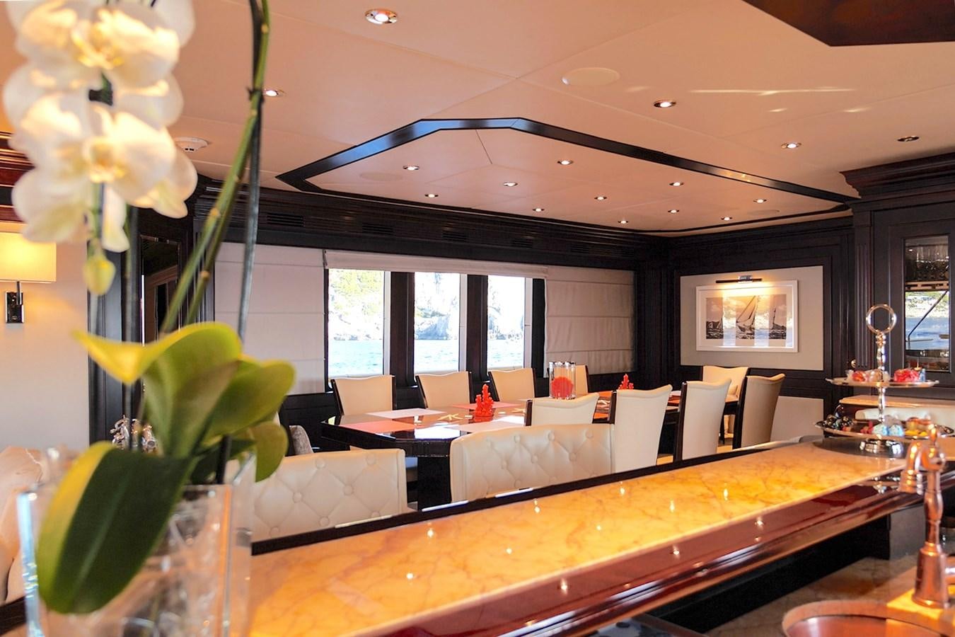 a room with a large table and chairs and a large window aboard LIBERTA Yacht for Sale