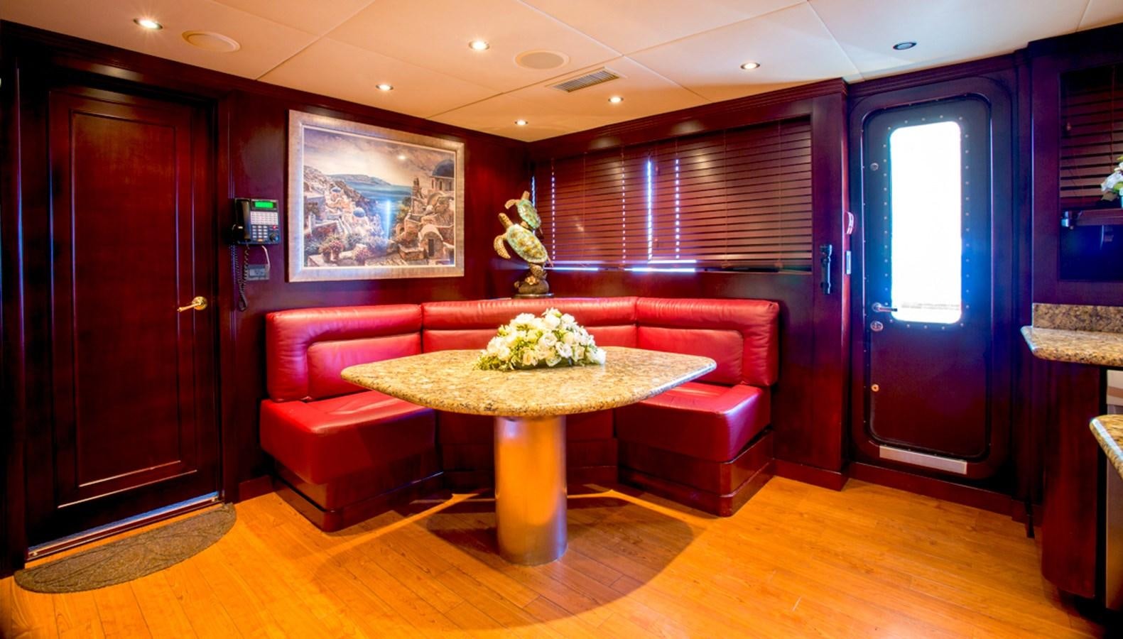 a room with a table and chairs aboard LIBERTA Yacht for Sale