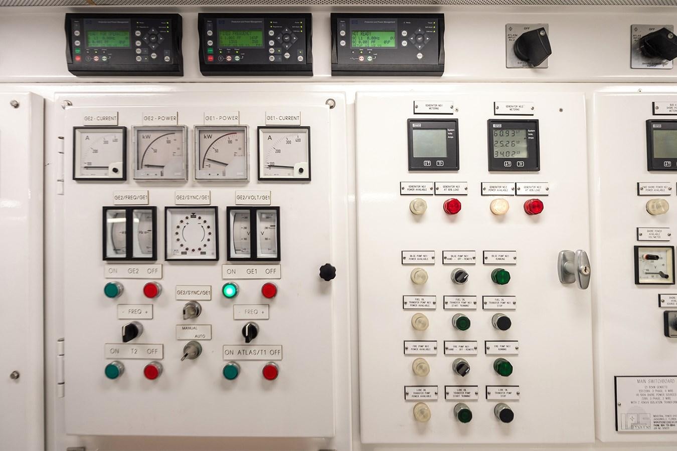 a white control panel with buttons and switches aboard LIBERTA Yacht for Sale