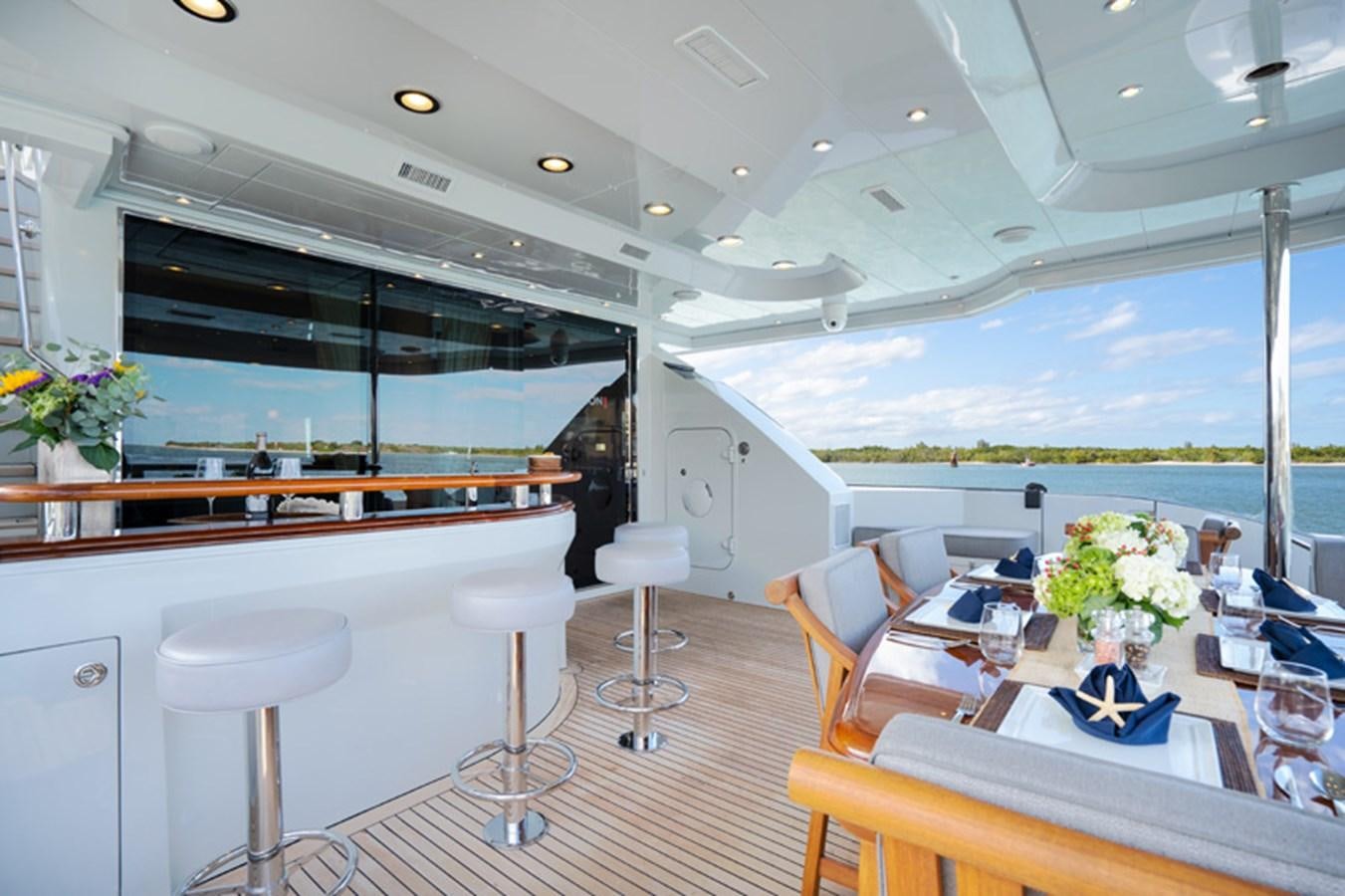 a room with tables and chairs aboard TEMPTATION Yacht for Sale