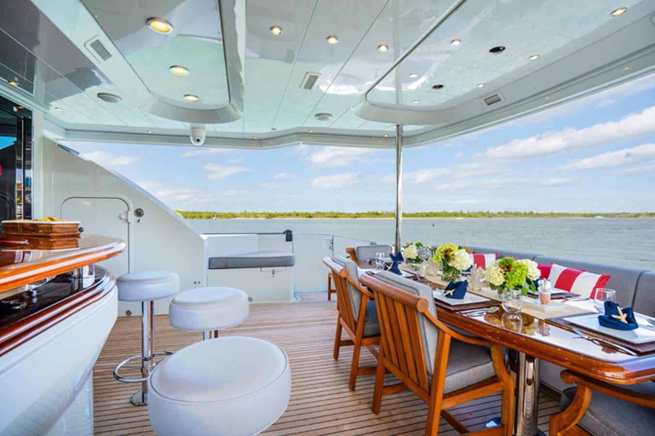 a room with tables and chairs aboard TEMPTATION Yacht for Sale