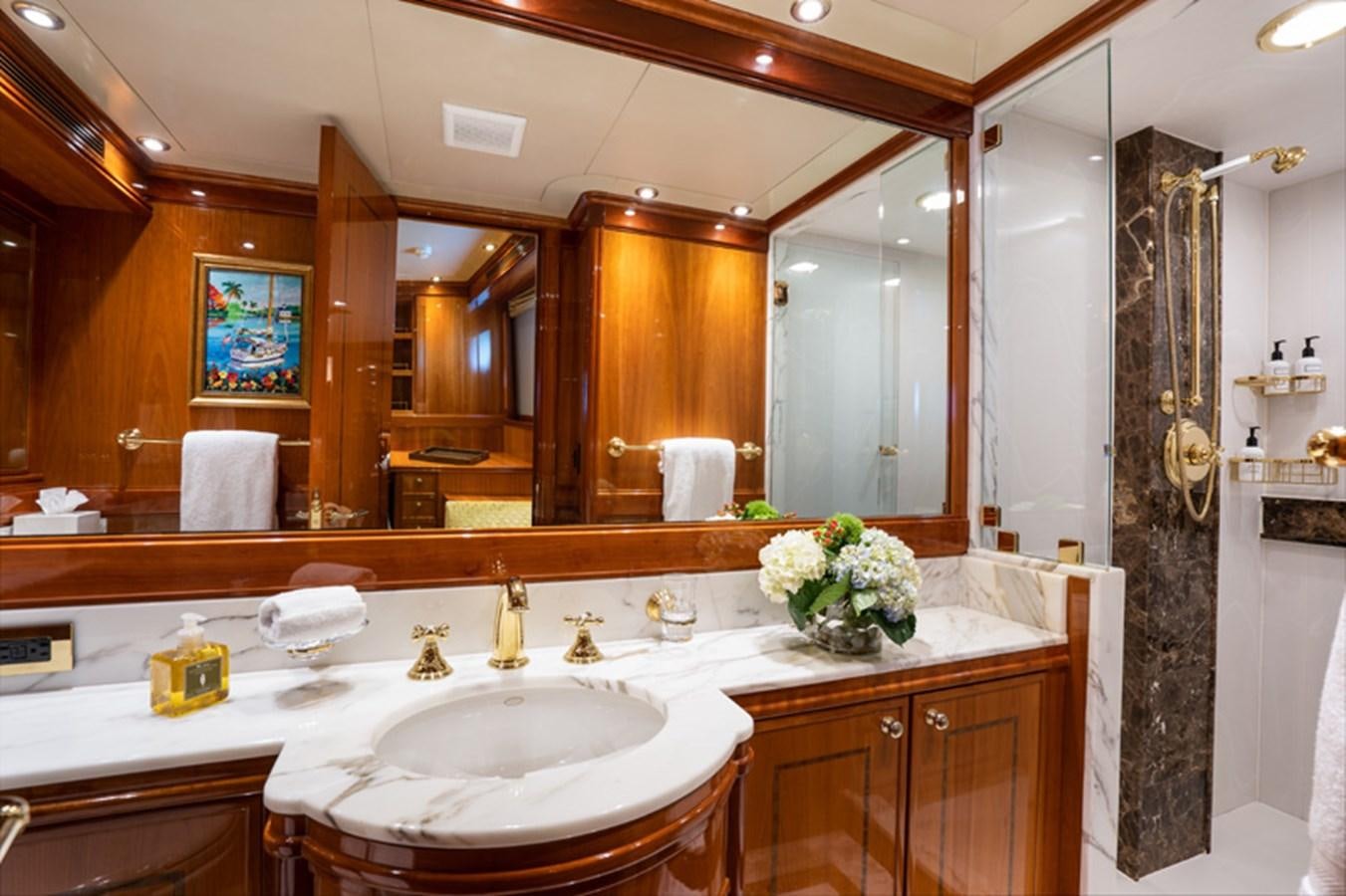 a bathroom with a large mirror aboard TEMPTATION Yacht for Sale