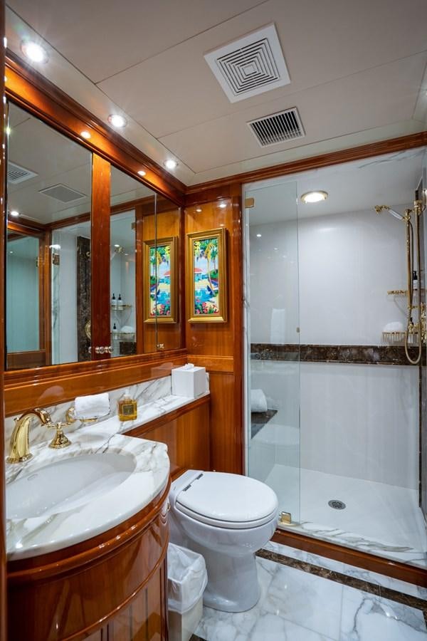 a bathroom with a toilet and a sink aboard TEMPTATION Yacht for Sale