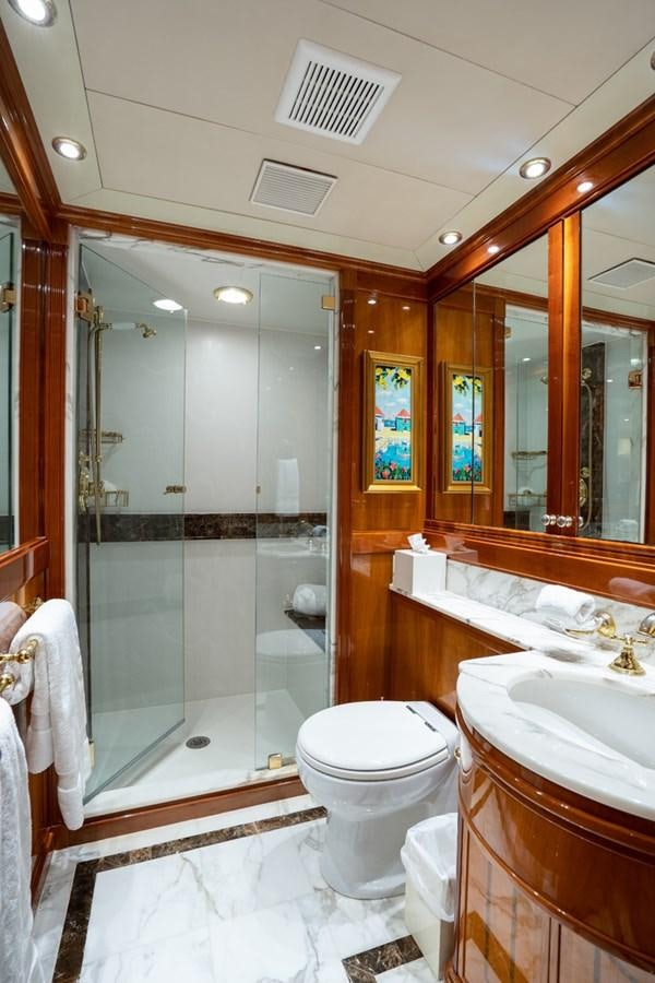 a bathroom with a glass shower aboard TEMPTATION Yacht for Sale