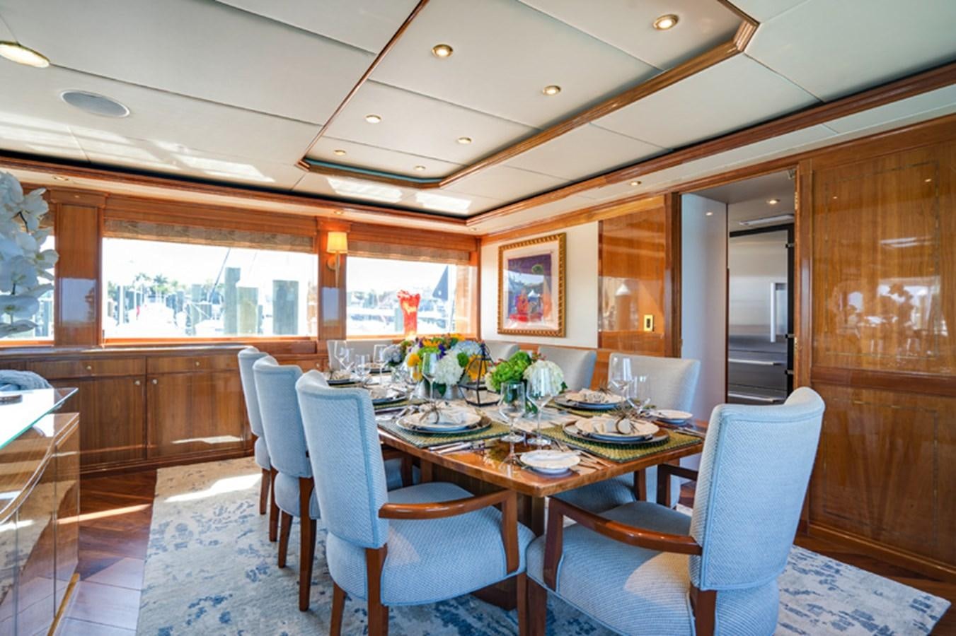 a dining room with a table aboard TEMPTATION Yacht for Sale