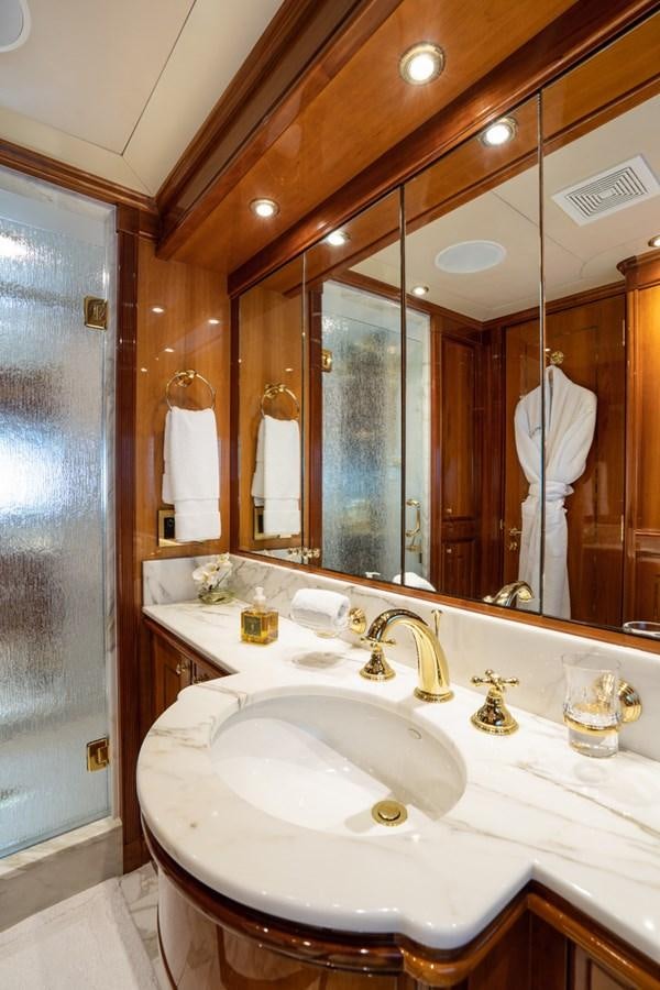 a bathroom with a large mirror aboard TEMPTATION Yacht for Sale
