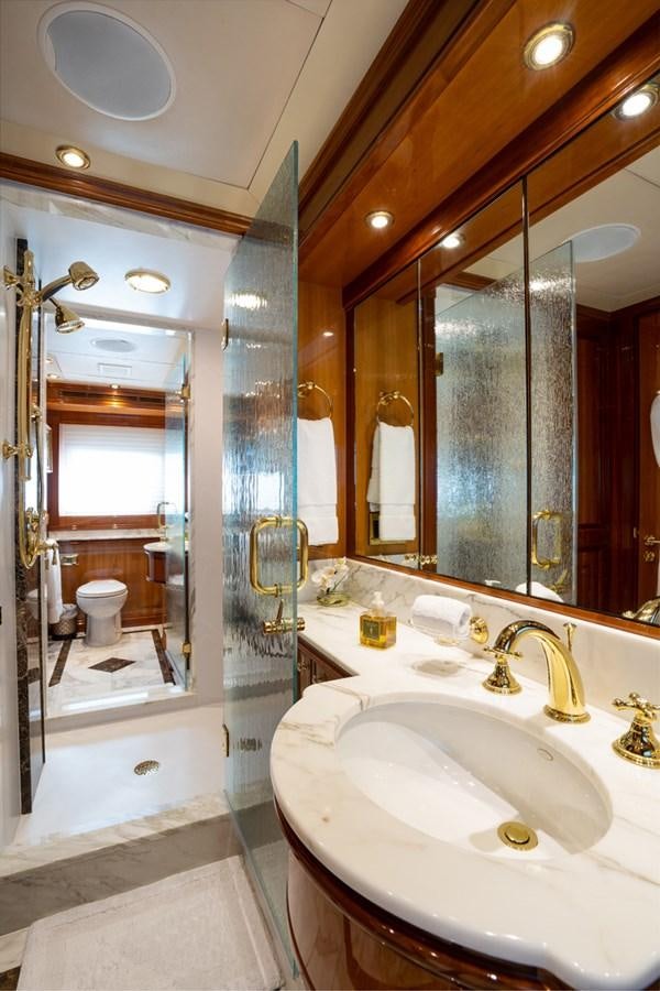a bathroom with a glass shower aboard TEMPTATION Yacht for Sale