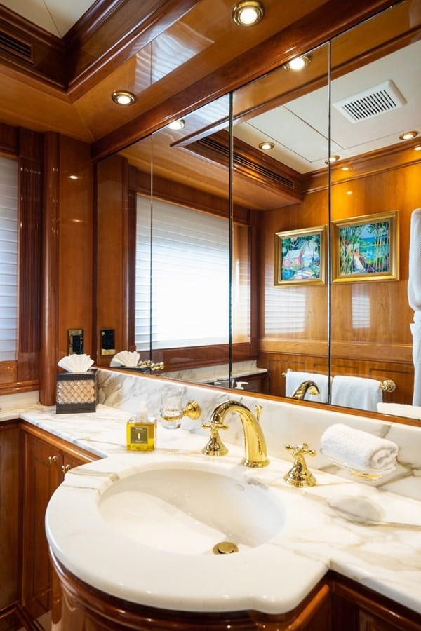 a bathroom with a large mirror aboard TEMPTATION Yacht for Sale