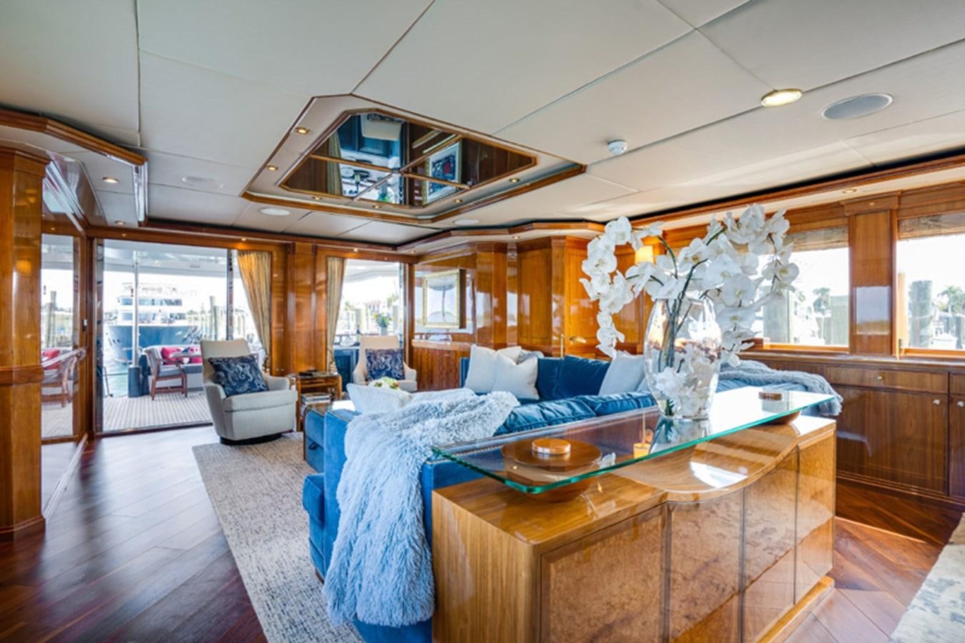 a large living room with a large glass ceiling aboard TEMPTATION Yacht for Sale