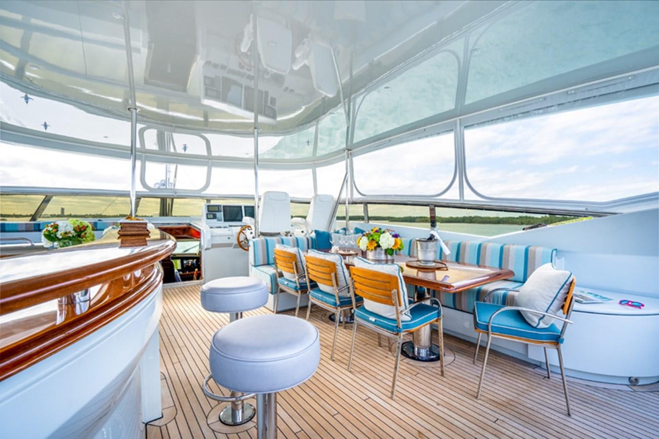 a room with tables and chairs aboard TEMPTATION Yacht for Sale