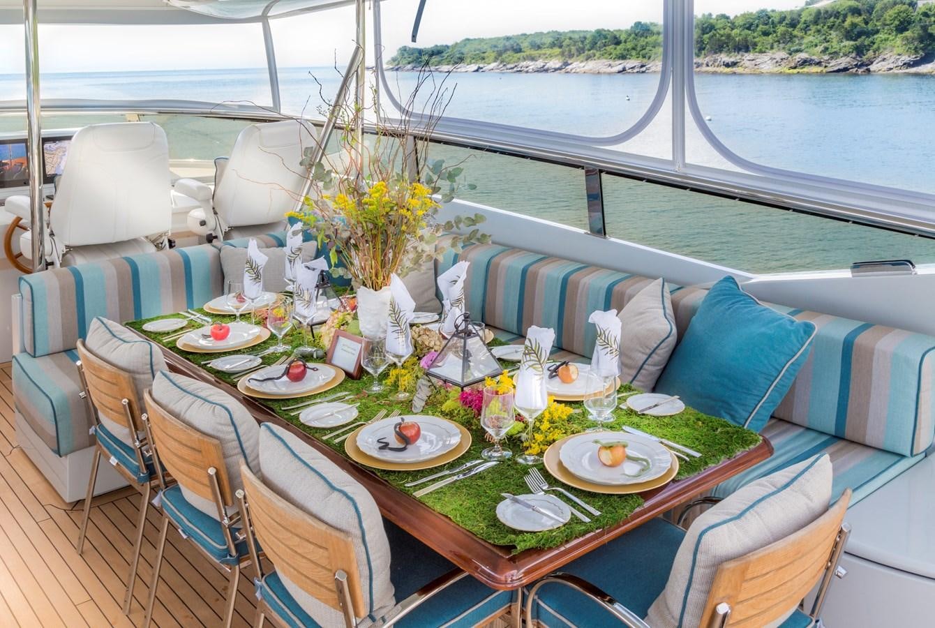 a table set for a dinner aboard TEMPTATION Yacht for Sale