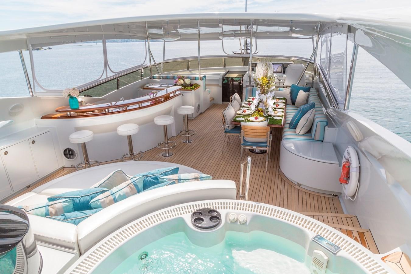 a large room with a pool table and chairs aboard TEMPTATION Yacht for Sale