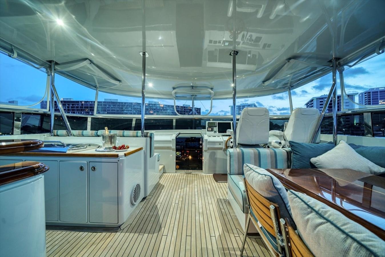 a large boat with a large deck aboard TEMPTATION Yacht for Sale