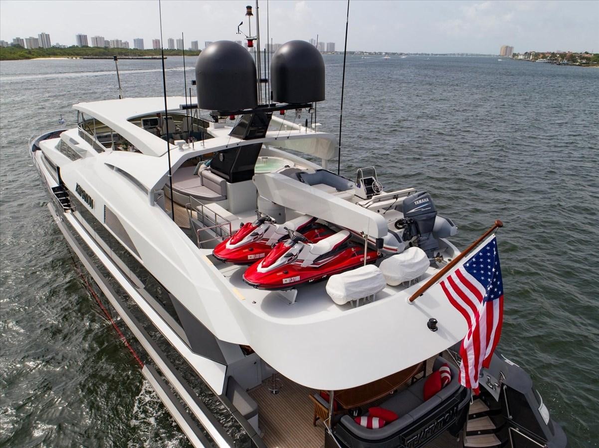 a boat with a flag on it aboard TEMPTATION Yacht for Sale