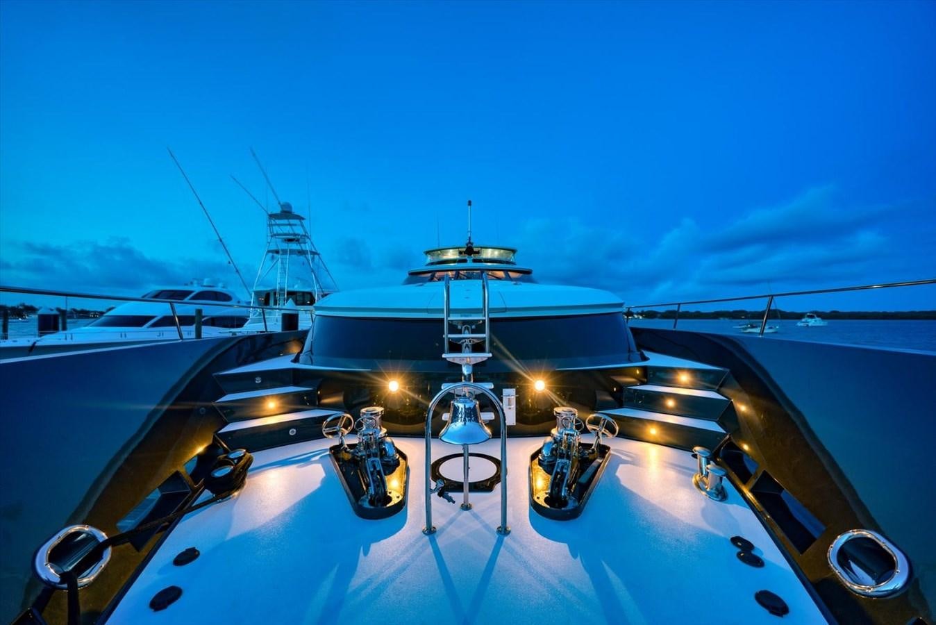 a large ship with a deck and a couple of chairs on it aboard TEMPTATION Yacht for Sale