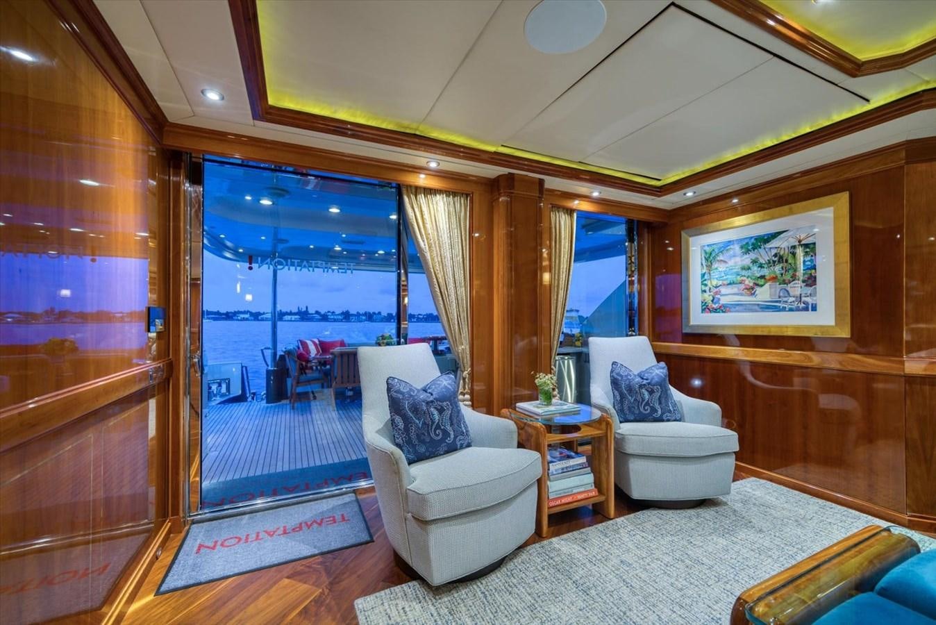 a living room with a large window aboard TEMPTATION Yacht for Sale