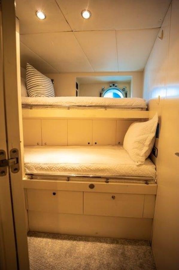 a room with a bed and a mirror aboard NYHAVEN Yacht for Sale