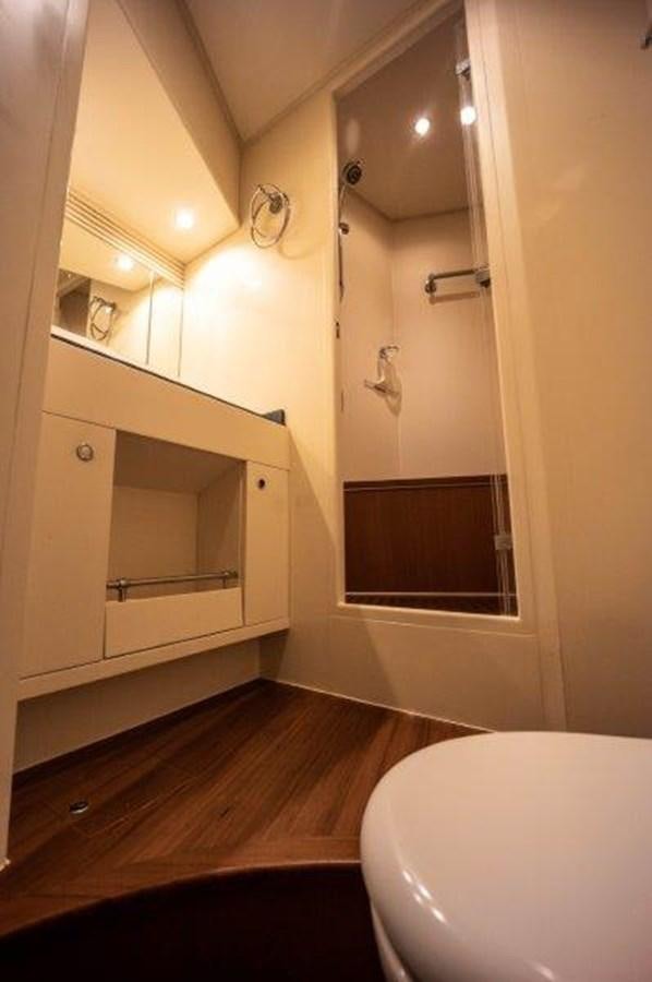 a bathroom with a toilet and a mirror aboard NYHAVEN Yacht for Sale