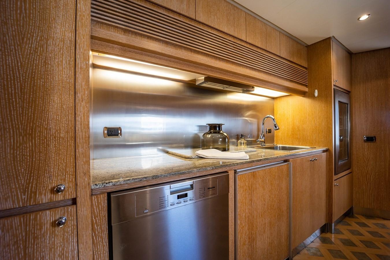 a kitchen with a steel chimney aboard NYHAVEN Yacht for Sale