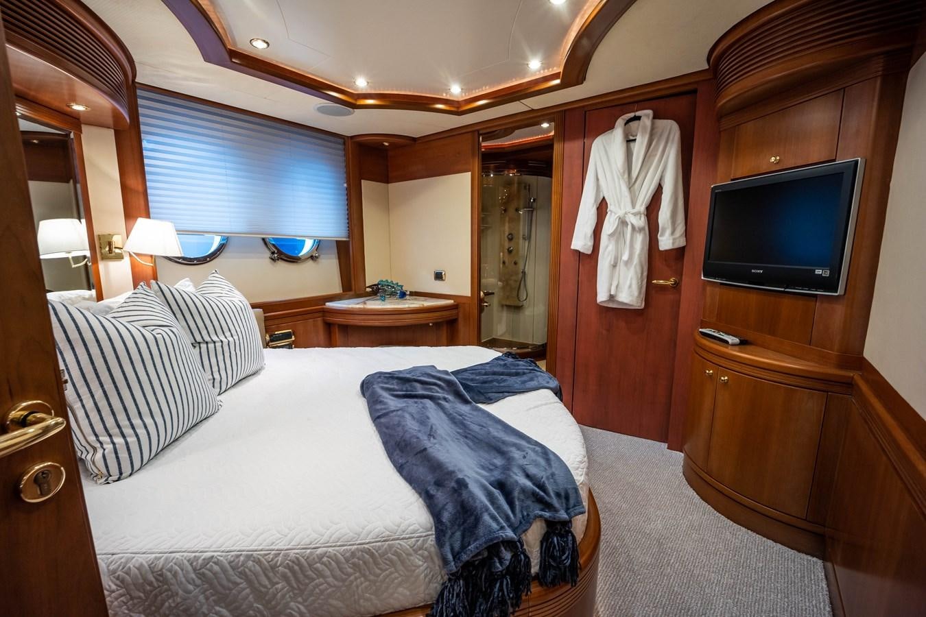 a hotel room with a bed and television aboard NYHAVEN Yacht for Sale