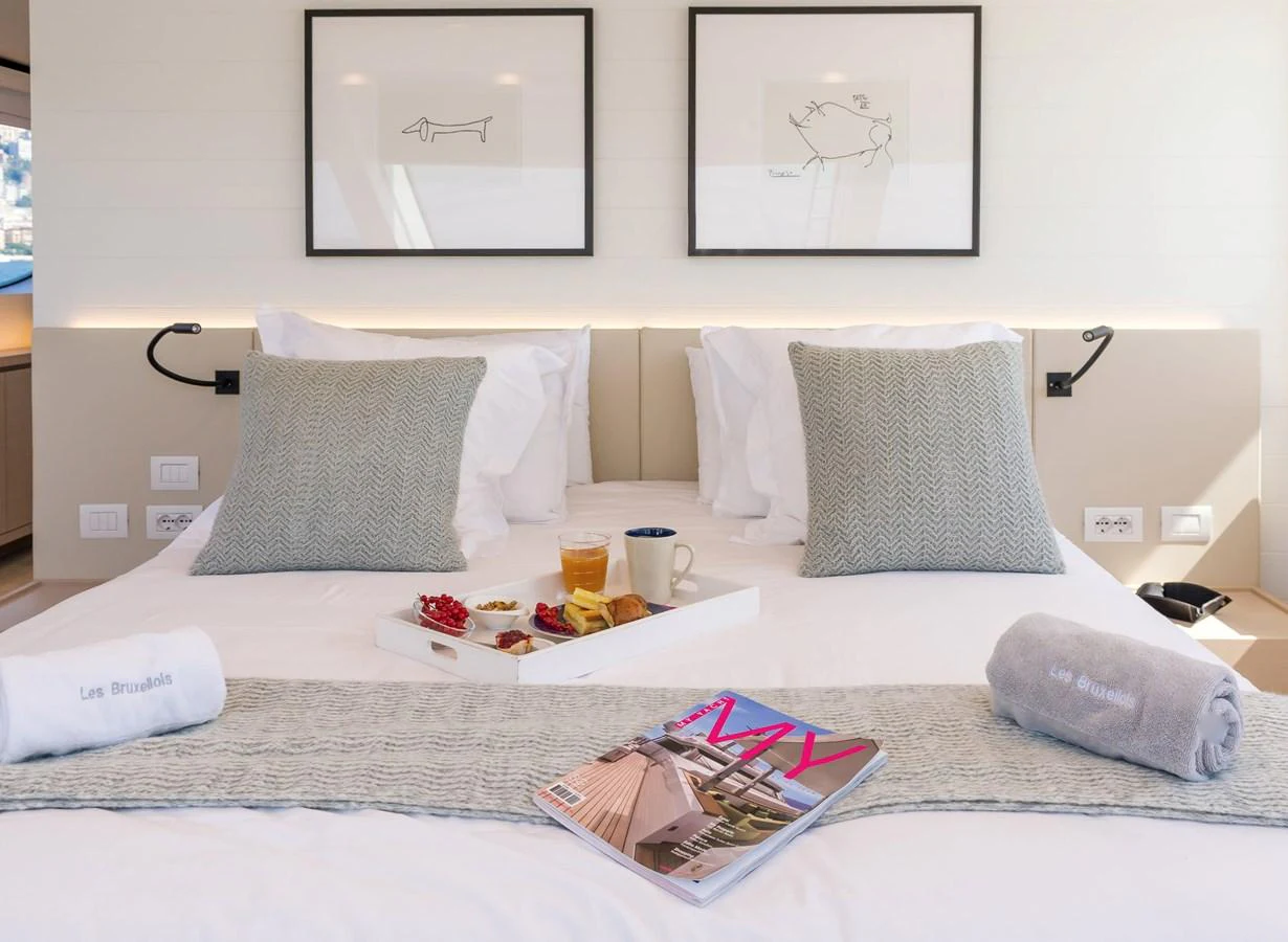 a bed with pillows and a tray of food on it aboard SANLORENZO SD112 Yacht for Sale