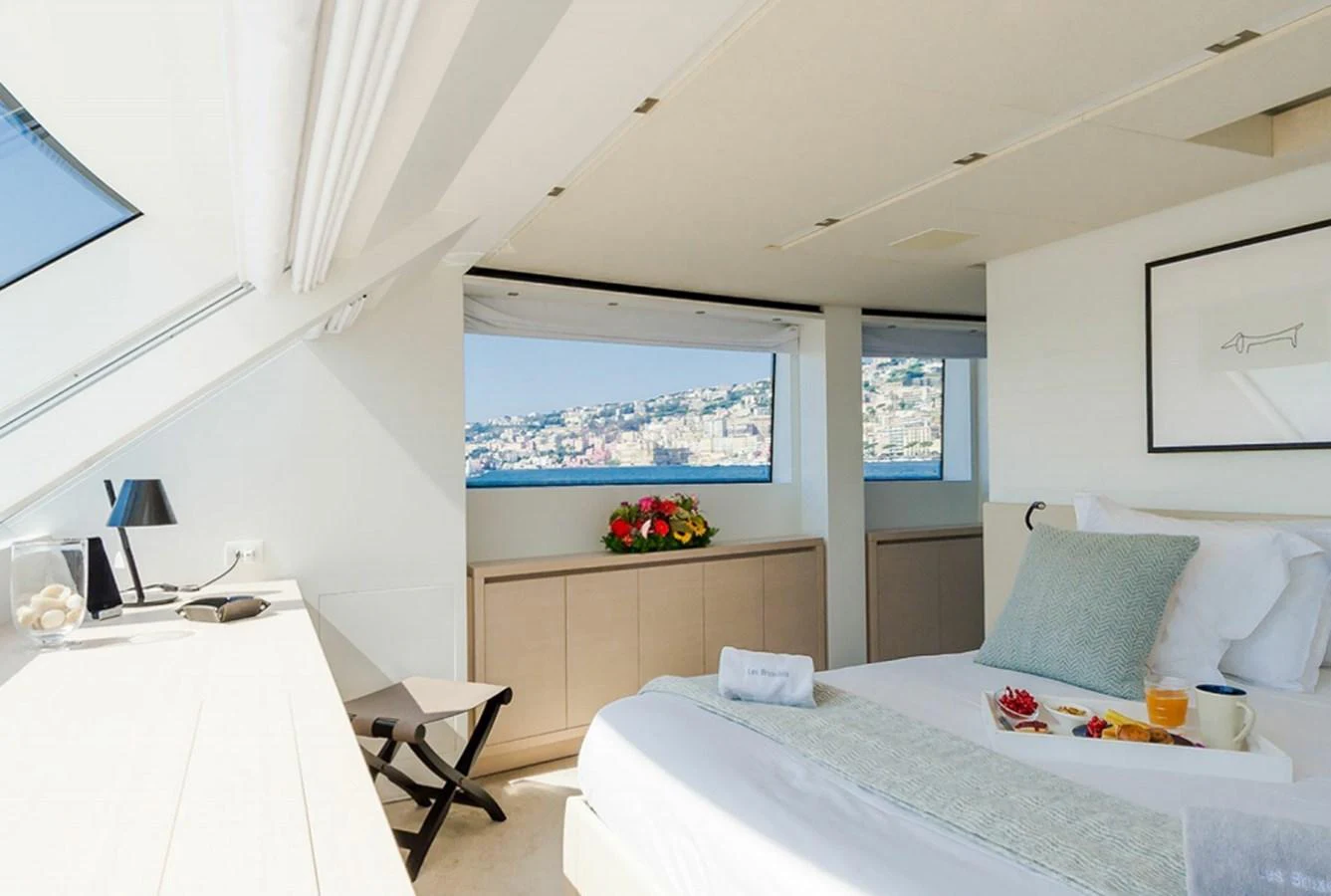 a bedroom with a bed and a desk aboard SANLORENZO SD112 Yacht for Sale