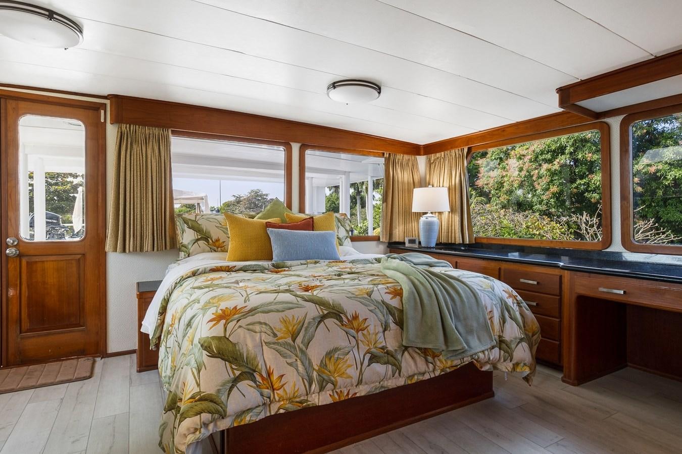 a bedroom with a bed and a lamp aboard MOVIE SET Yacht for Sale