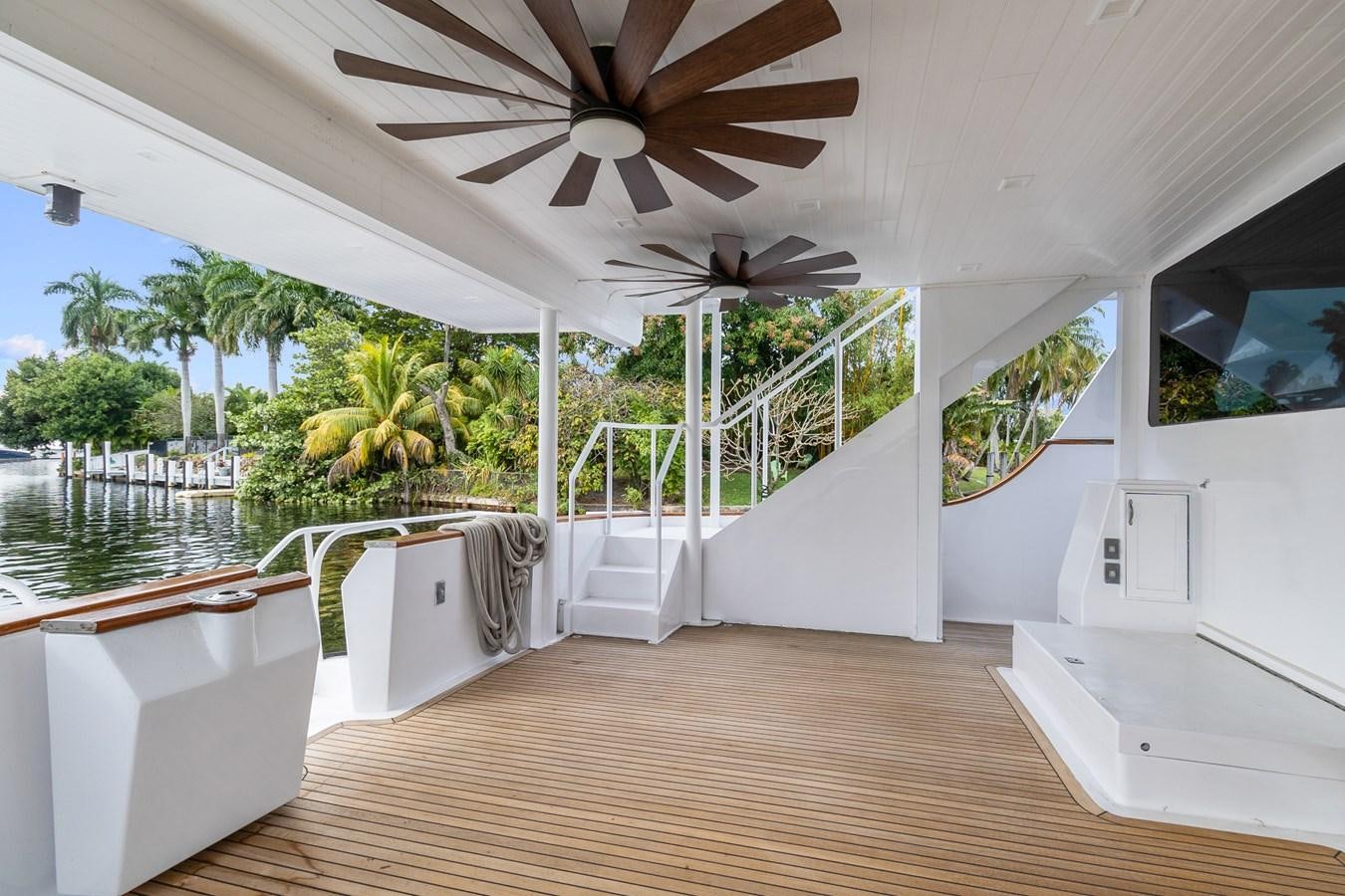 a large white house with a ceiling fan and a wooden floor aboard MOVIE SET Yacht for Sale