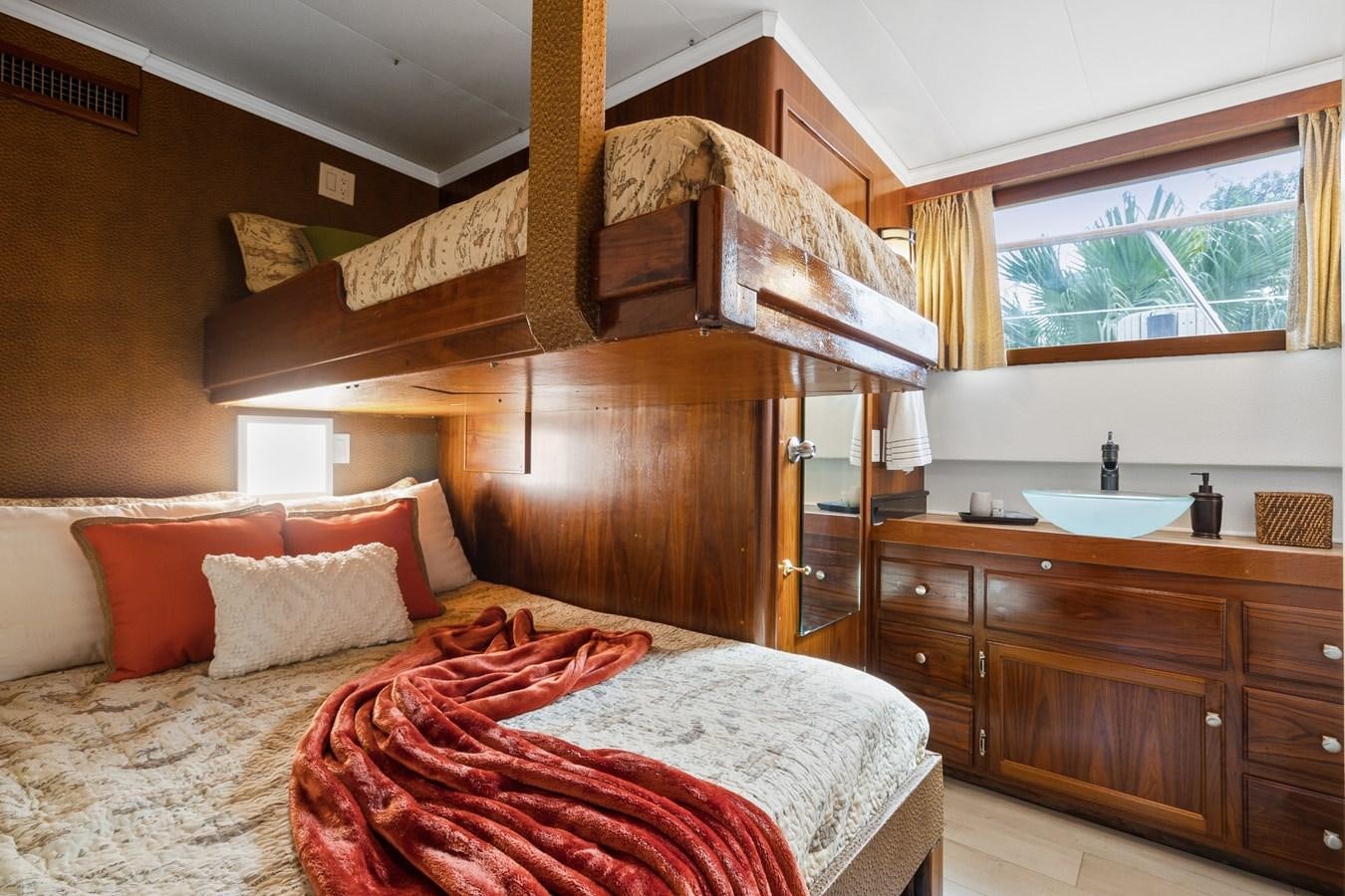 a bedroom with a bed and a sink aboard MOVIE SET Yacht for Sale