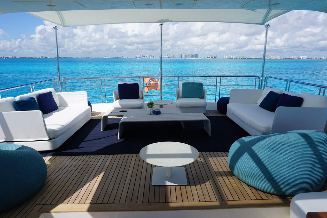 a room with a table chairs and a large body of water aboard VICTORIOUS Yacht for Sale