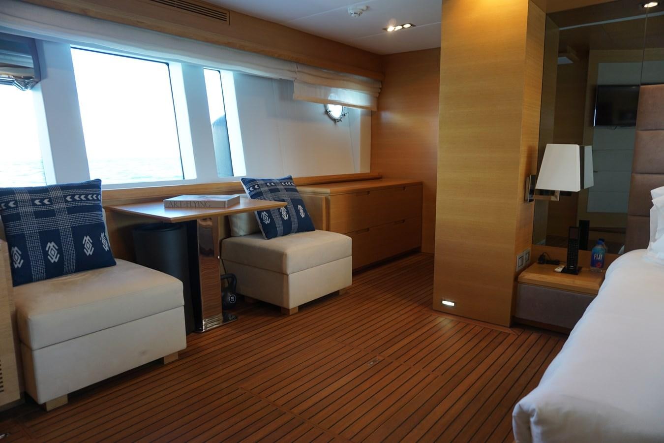 a room with a bed and a desk aboard VICTORIOUS Yacht for Sale