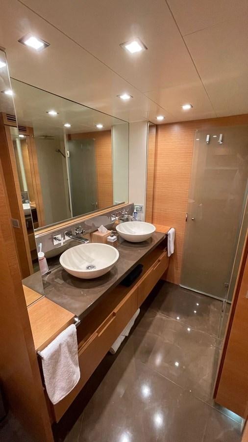 a bathroom with a sink and a mirror aboard VICTORIOUS Yacht for Sale
