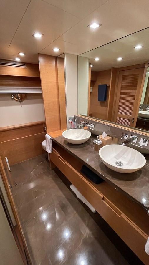 a bathroom with a countertop sink and a mirror aboard VICTORIOUS Yacht for Sale