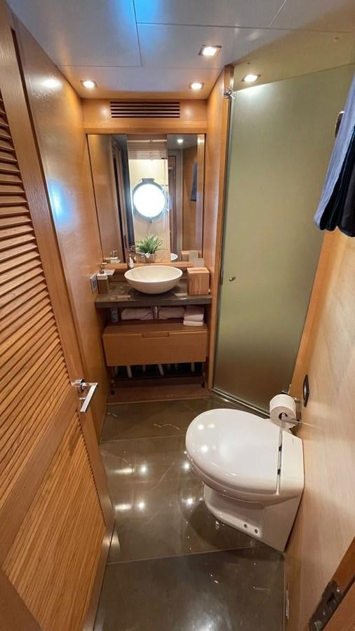 a bathroom with a toilet and a sink aboard VICTORIOUS Yacht for Sale