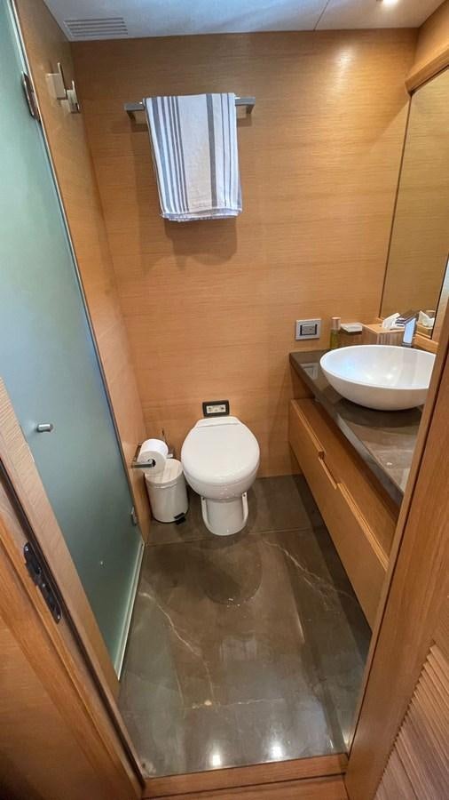 a bathroom with a toilet and sink aboard VICTORIOUS Yacht for Sale