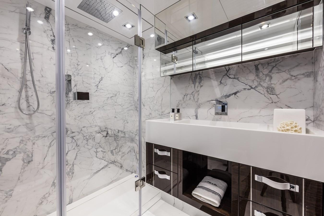 a bathroom with a glass wall aboard AMIRA Yacht for Sale