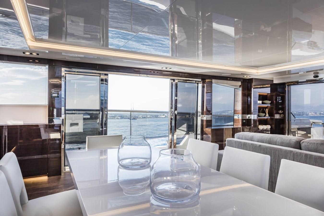 a room with tables and chairs aboard AMIRA Yacht for Sale