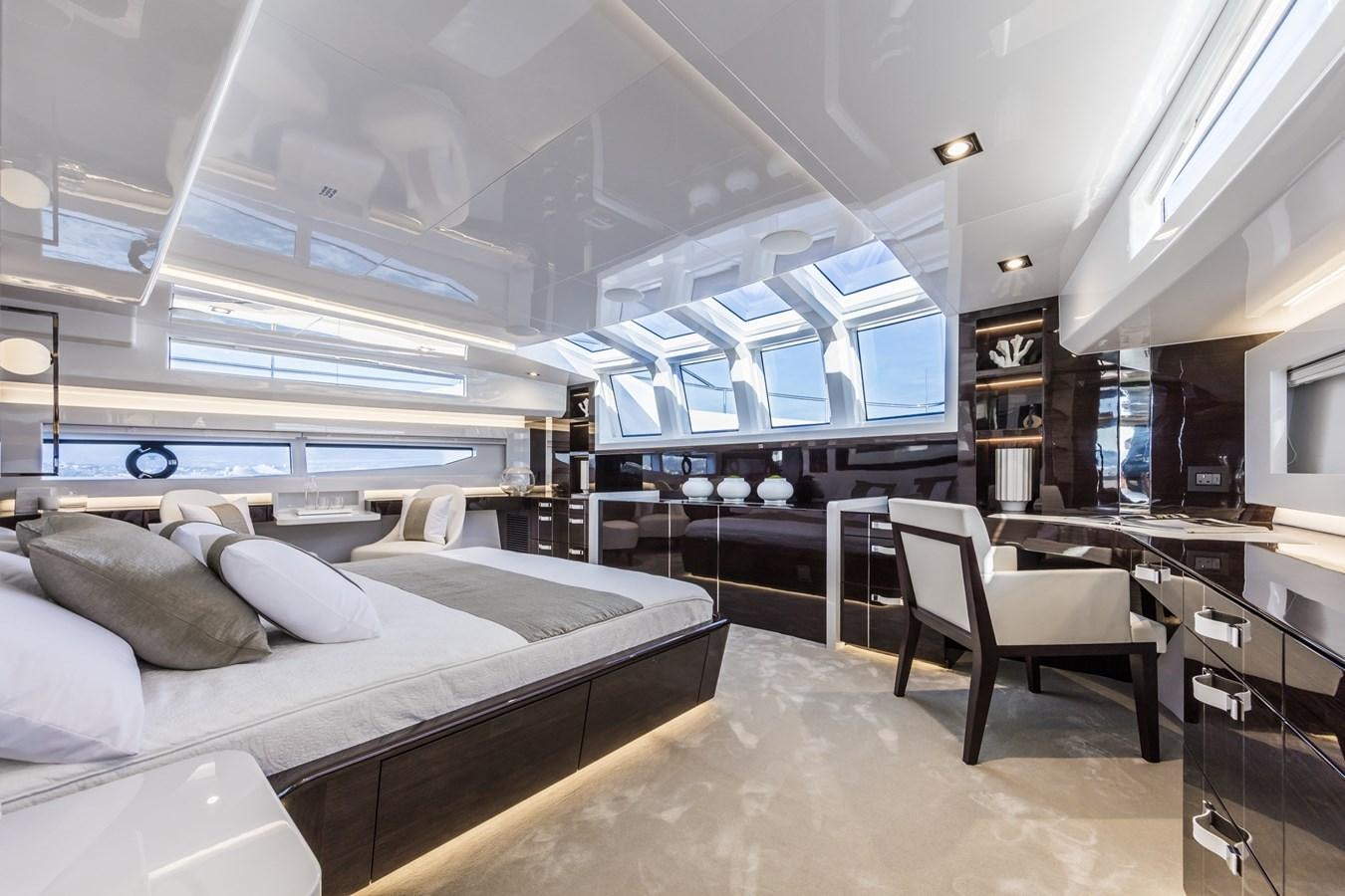 a room with a bed and a desk aboard AMIRA Yacht for Sale
