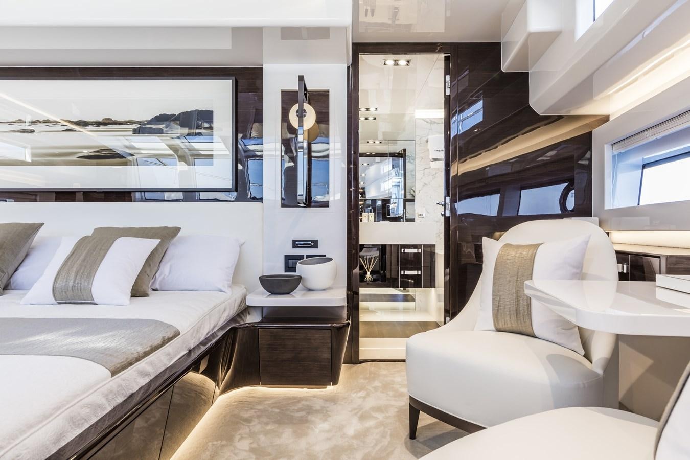 a room with a bed and a couch aboard AMIRA Yacht for Sale