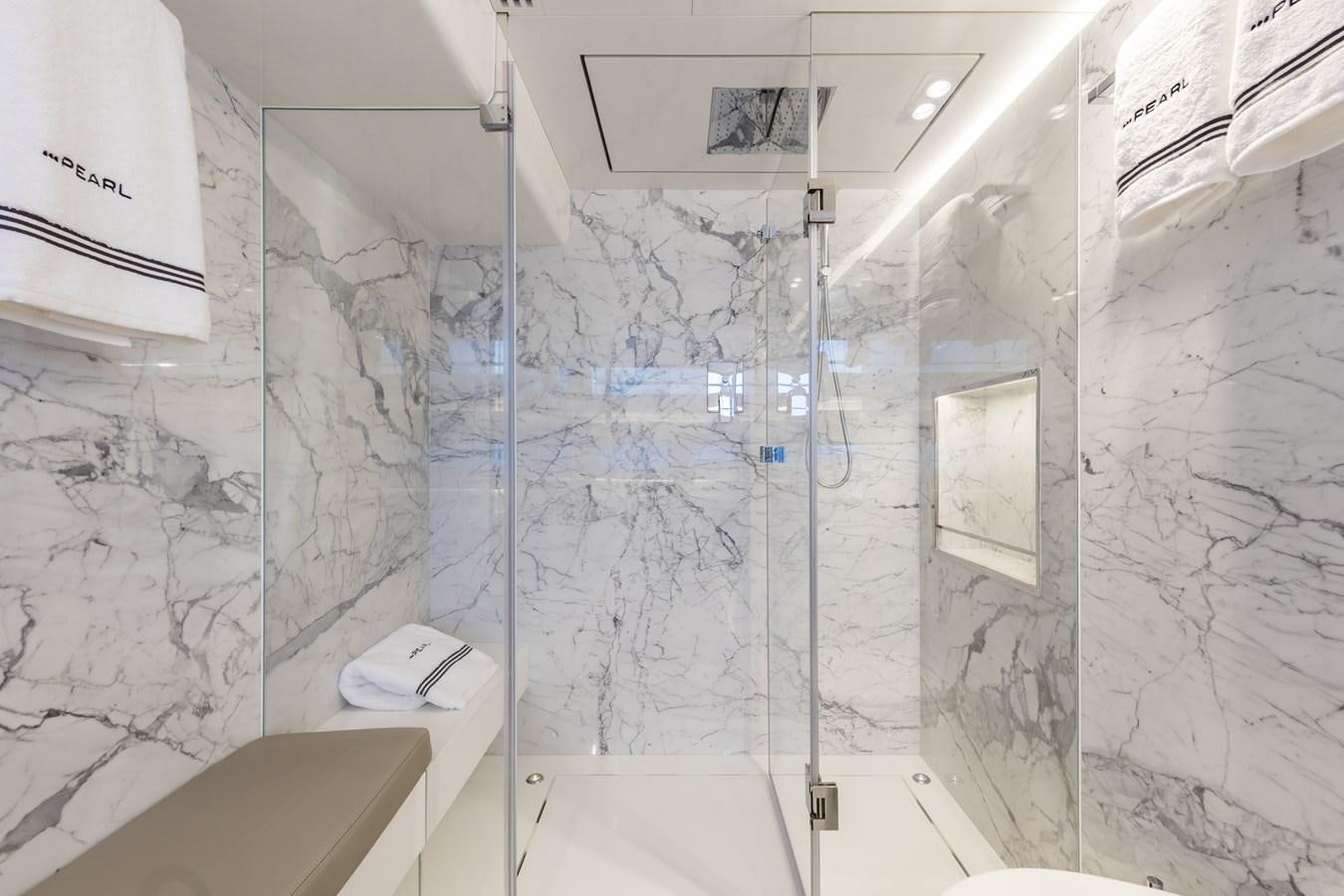 a bathroom with a glass shower aboard AMIRA Yacht for Sale