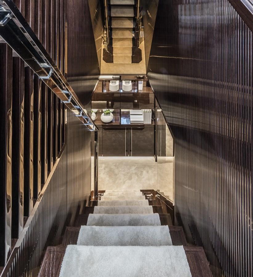 a long hallway with black and white striped walls aboard AMIRA Yacht for Sale